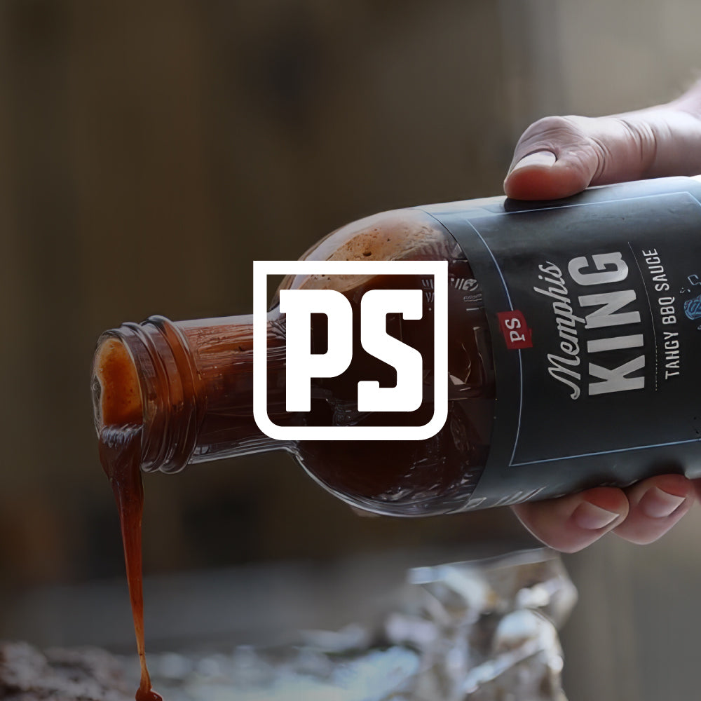 Hand holding a bottle of Memphis King BBQ sauce with a blurred background
