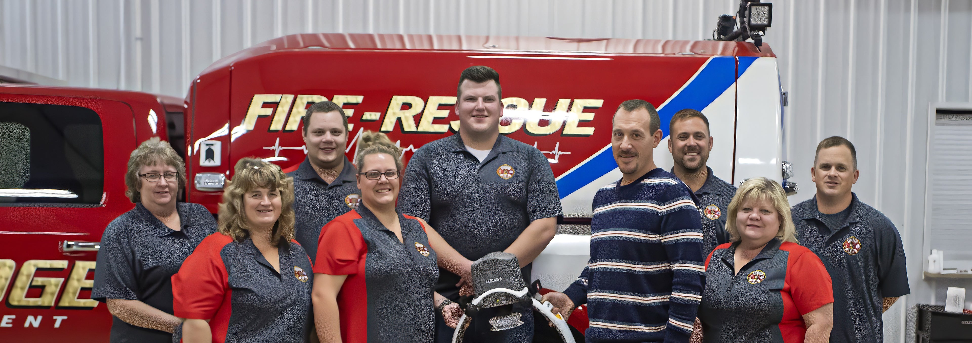 Group of firefighters and support staff in front of a fire truck